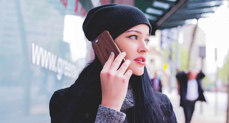 woman on cell phone calling about overdraft protection personal lending services